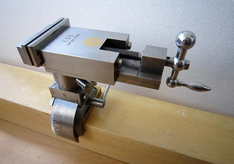 Precision parallel toolmaker's vise with custom mounting design, rotated transversely. Full 360° rotation possible.