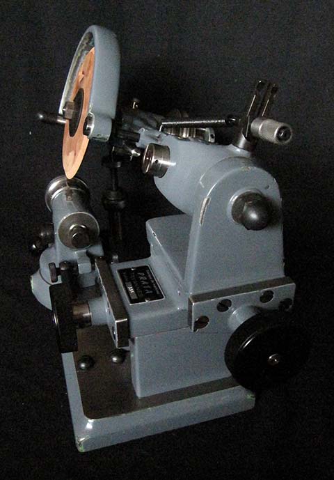 Prata Typ 11 pinion leaf polishing machine. Wooden polishing disk set at an angle.